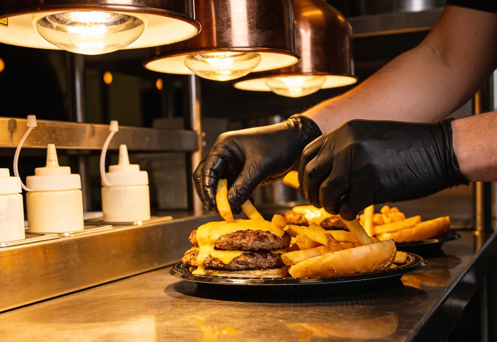 A restaurant kitchen pass with plain gallon sauce bottles
